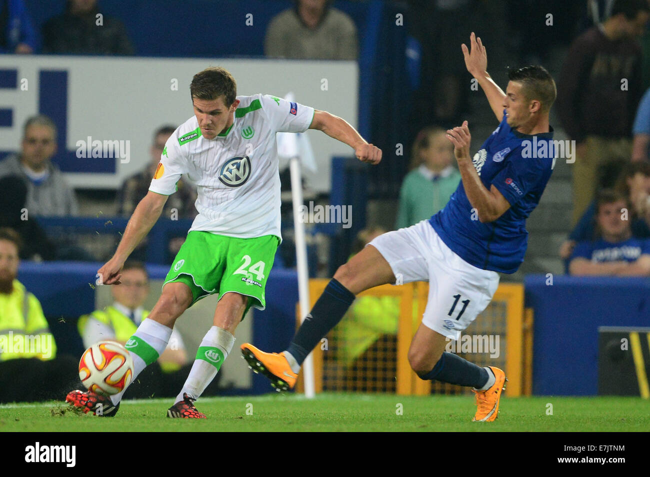 Liverpool, UK. 18th Sep, 2014. Everton's Kevin Mirallas (R) and Sebastian Jung of Wolfsburg vie for the ball during the UEFA Europa League group H soccer match between Everton FC and VfL Wolfsburg at the Goodison Park, Liverpool, Britain, 18 September 2014. © dpa picture alliance/Alamy Live News Stock Photo