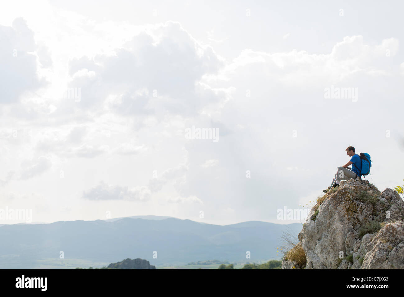 Young man hiking on the mountain Stock Photo - Alamy