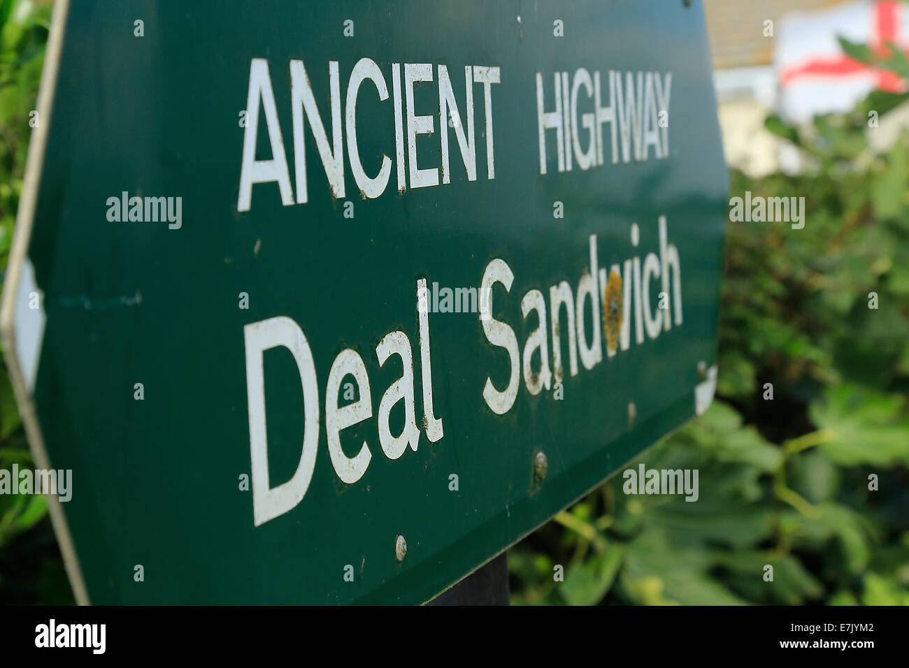 Ancient Highway sign Sandwich to Deal  with English flag in background. Stock Photo