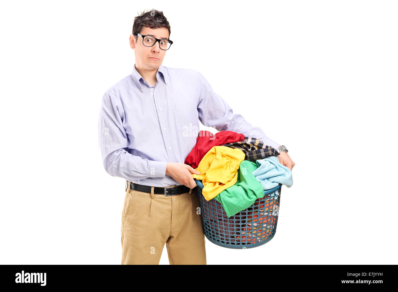 Terrified young man holding a laundry basket full of clothes isolated on white background Stock Photo