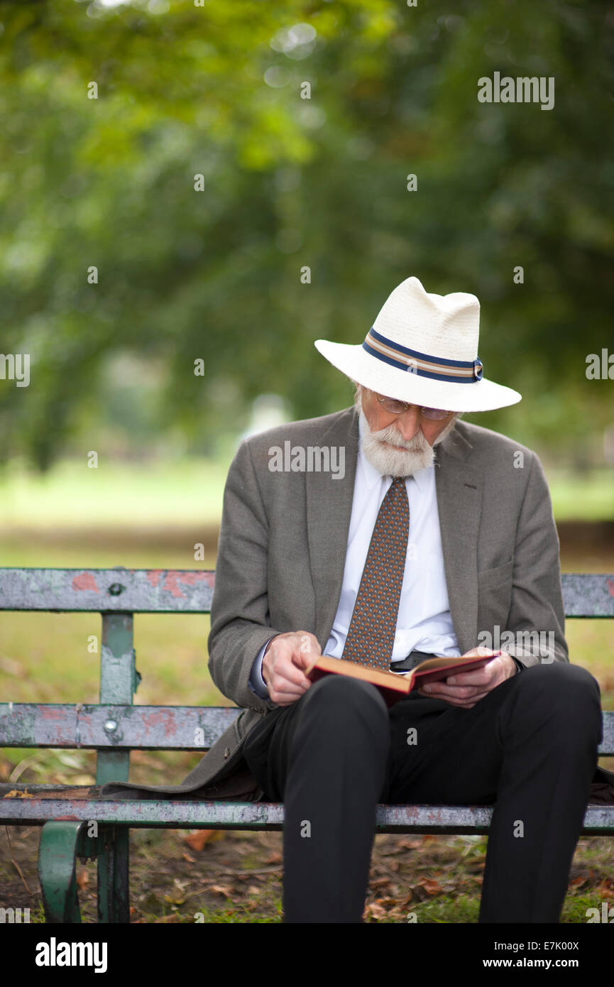 senior man reading a book on a park bench Stock Photo - Alamy
