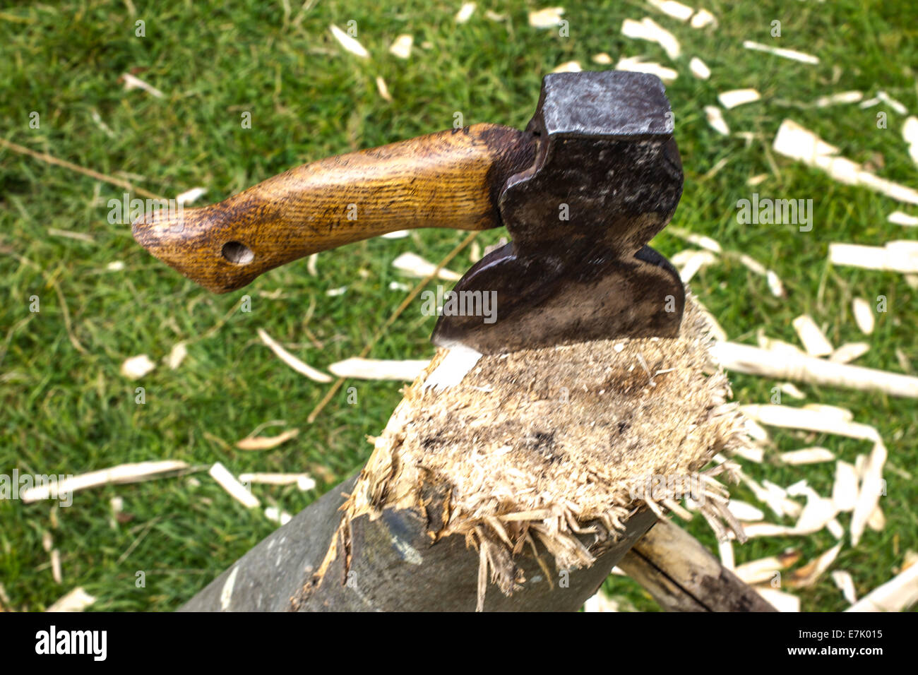 A axe stuck in a wood log Stock Photo