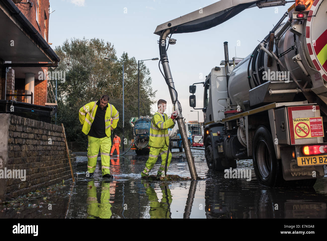 London, UK. 19th September, 2014. Workmen use a suction pump as torrential rains cause floods and travel disruptions in East London.  Credit:  Piero Cruciatti/Alamy Live News Stock Photo