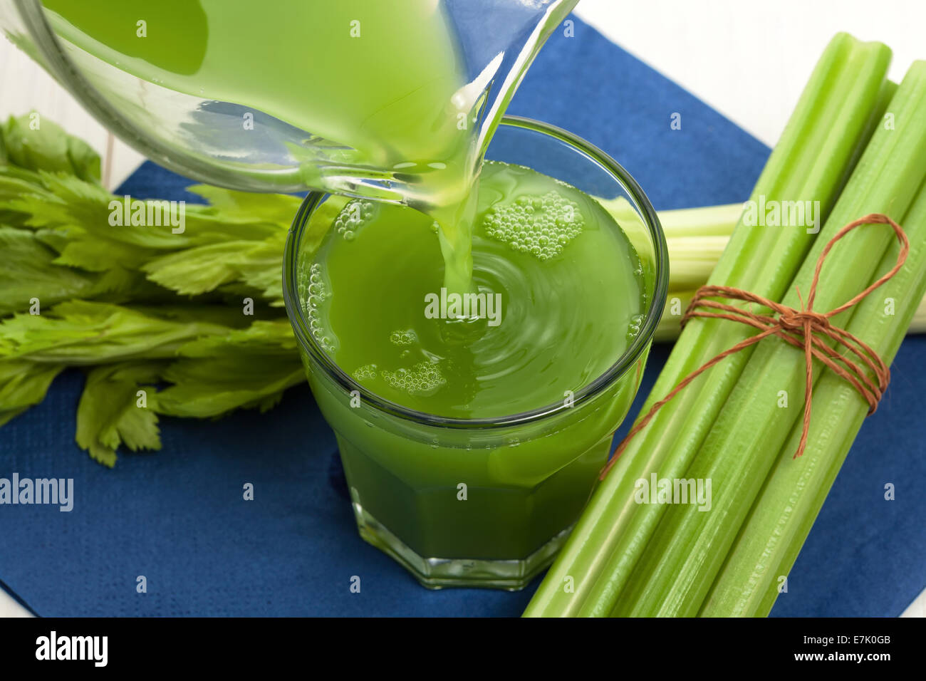 Green vegetable juice with celery stalk Stock Photo