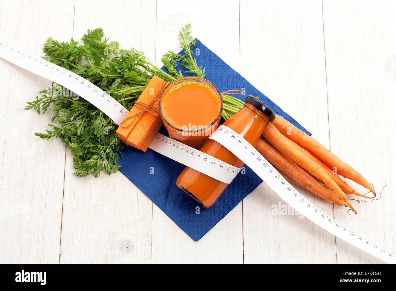 Carrot juice for healthy dieting on white wood Stock Photo