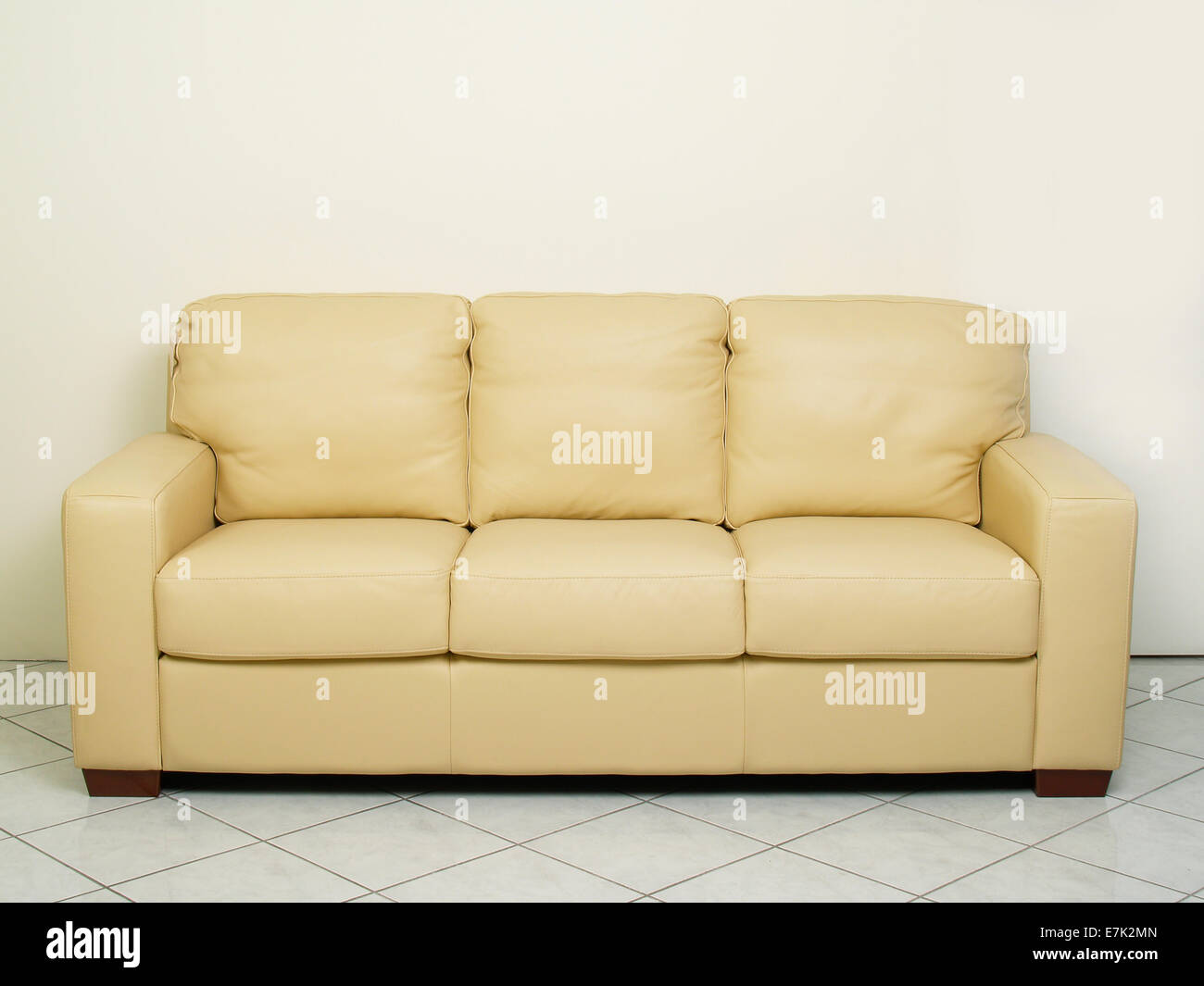 Three seater yellow beige couch / sofa Stock Photo