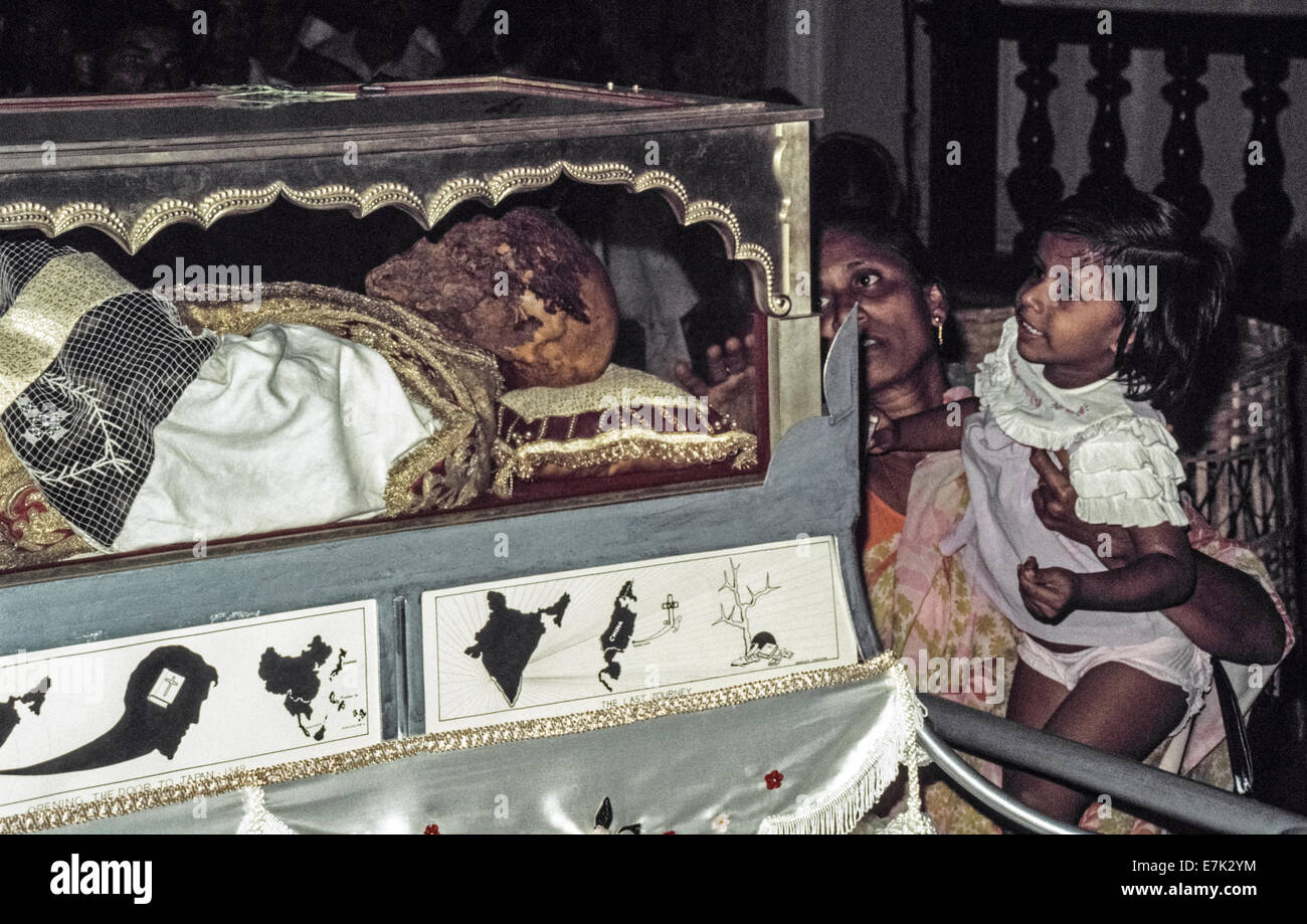 The body of Saint Francis Xavier is viewed through its glass and silver casket in 1974 inside the Se Cathedral after being brought from its final resting place in the nearby  Basilica Bom Jesus during the Solemn Exposition of his sacred relics that occurs every 10 years in Goa, India. As the first Jesuit missionary and co-founder of the Society of Jesus, Xavier arrived in Goa in 1542 to restore Christianity to the Portuguese settlers there and elsewhere in Asia. The Pope declared him a saint 70 years after his death in 1552. Historical photo. Stock Photo