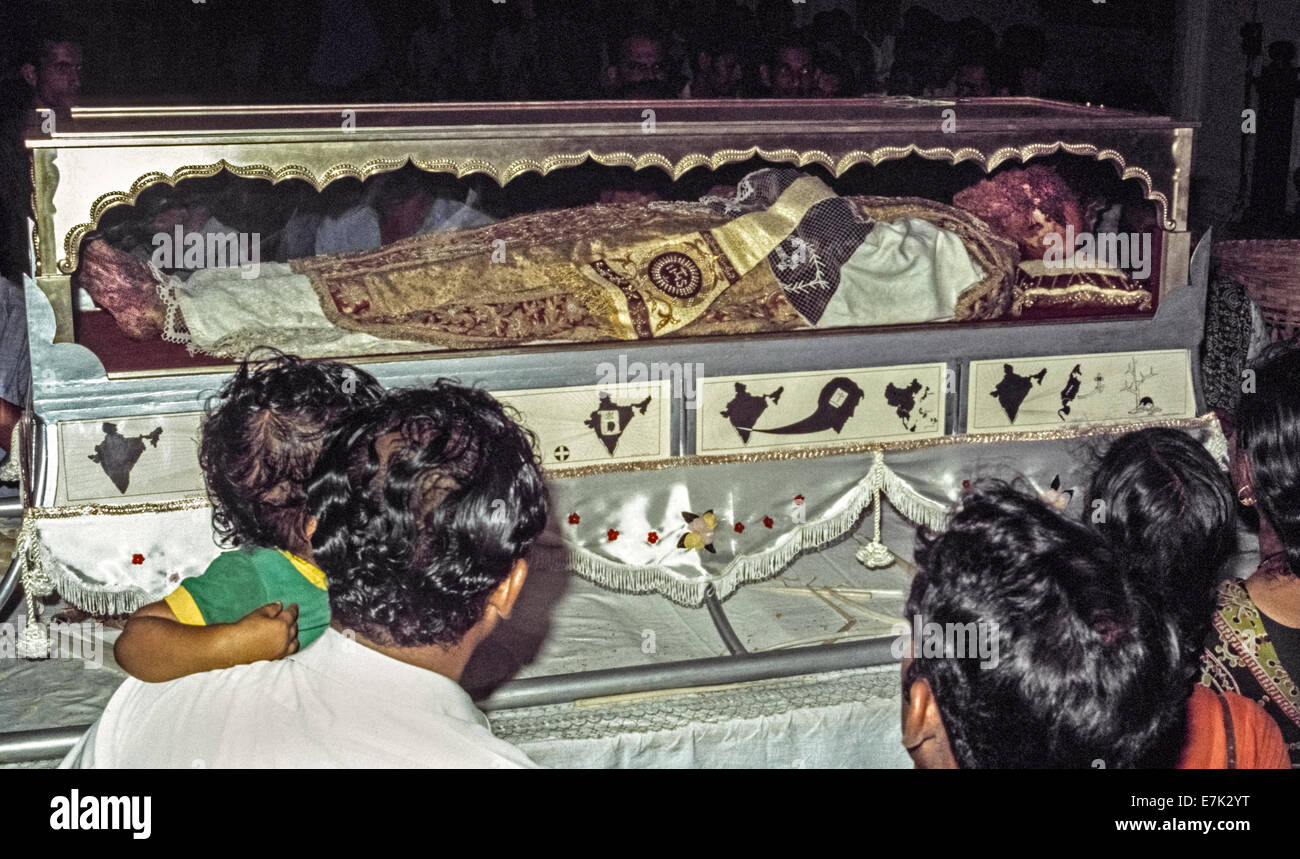 The body of Saint Francis Xavier is viewed through its glass and silver casket in 1974 inside the Se Cathedral after being brought from its final resting place in the nearby  Basilica Bom Jesus during the Solemn Exposition of his sacred relics that occurs every 10 years in Goa, India. As the first Jesuit missionary and co-founder of the Society of Jesus, Xavier arrived in Goa in 1542 to restore Christianity to the Portuguese settlers there and elsewhere in Asia. The Pope declared him a saint 70 years after his death in 1552. Historical photo. Stock Photo