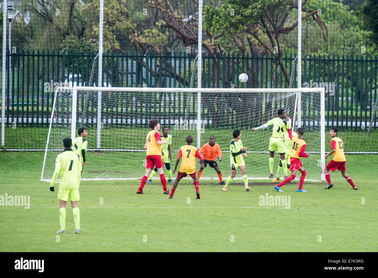 Youth football players challenging for the ball in front of the goal, Cape Town, South Africa