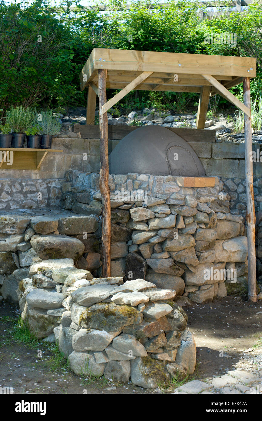 Earth cob clay oven project. The base is done the oven mass dome done now its ready for the insulation layer Stock Photo