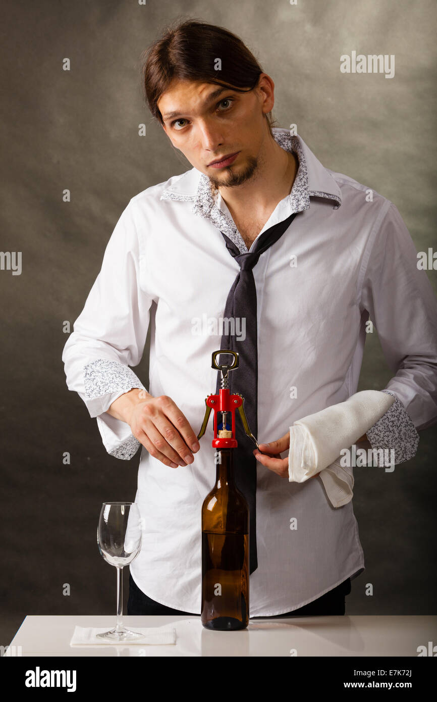 Man waiter opening bottle of wine with corkscrew Stock Photo Alamy