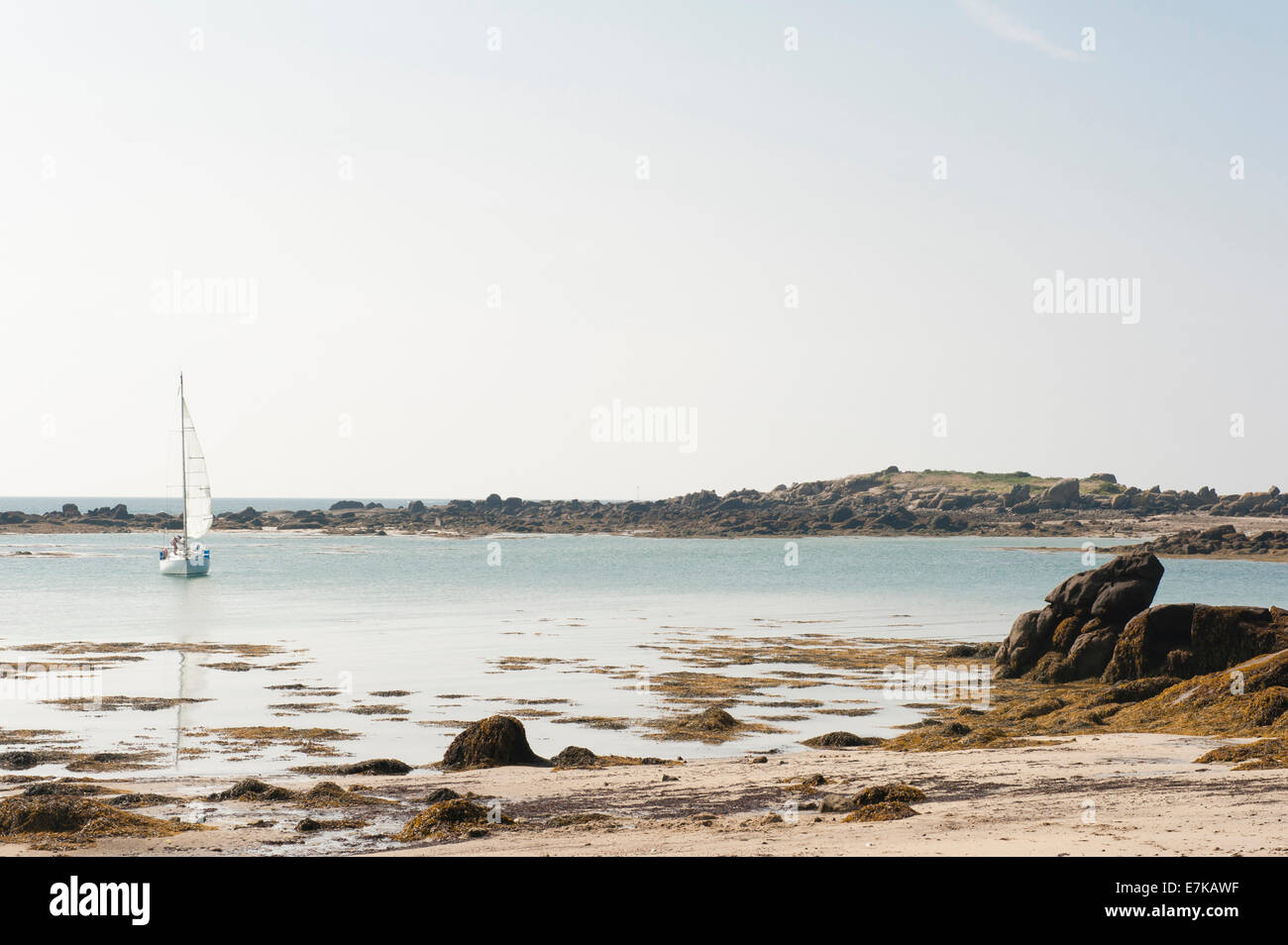 Boat sailing into the bay below the Fort de Matignon at low tide at Grand-Île, Chausey Islands, Basse-Normandie, France Stock Photo
