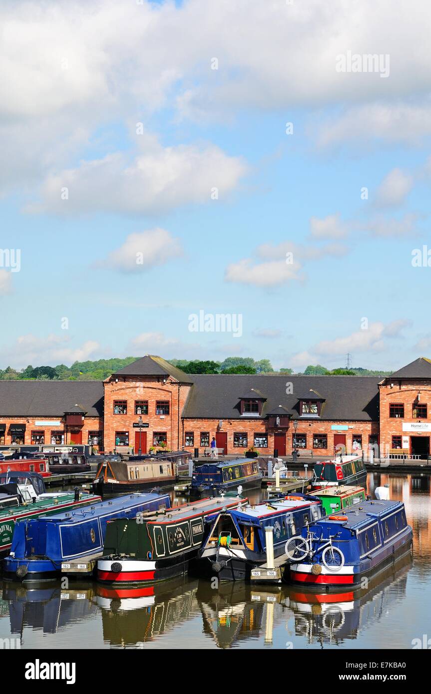 Narrowboats on their moorings in the canal basin with shops, bars and