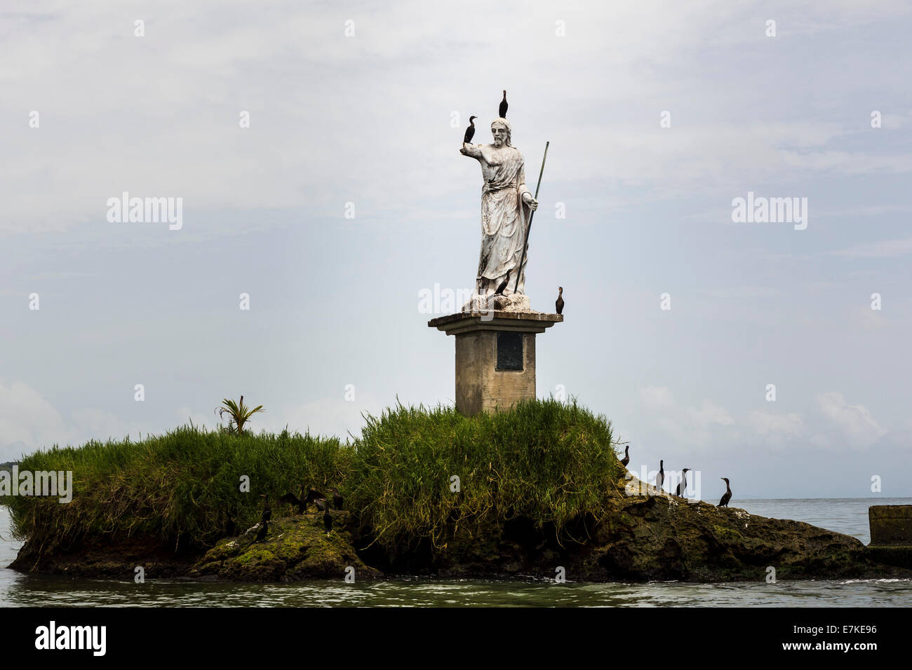 Birds on the Statue of Salvador del Mundo on the coast of Livingston, Guatemala Stock Photo