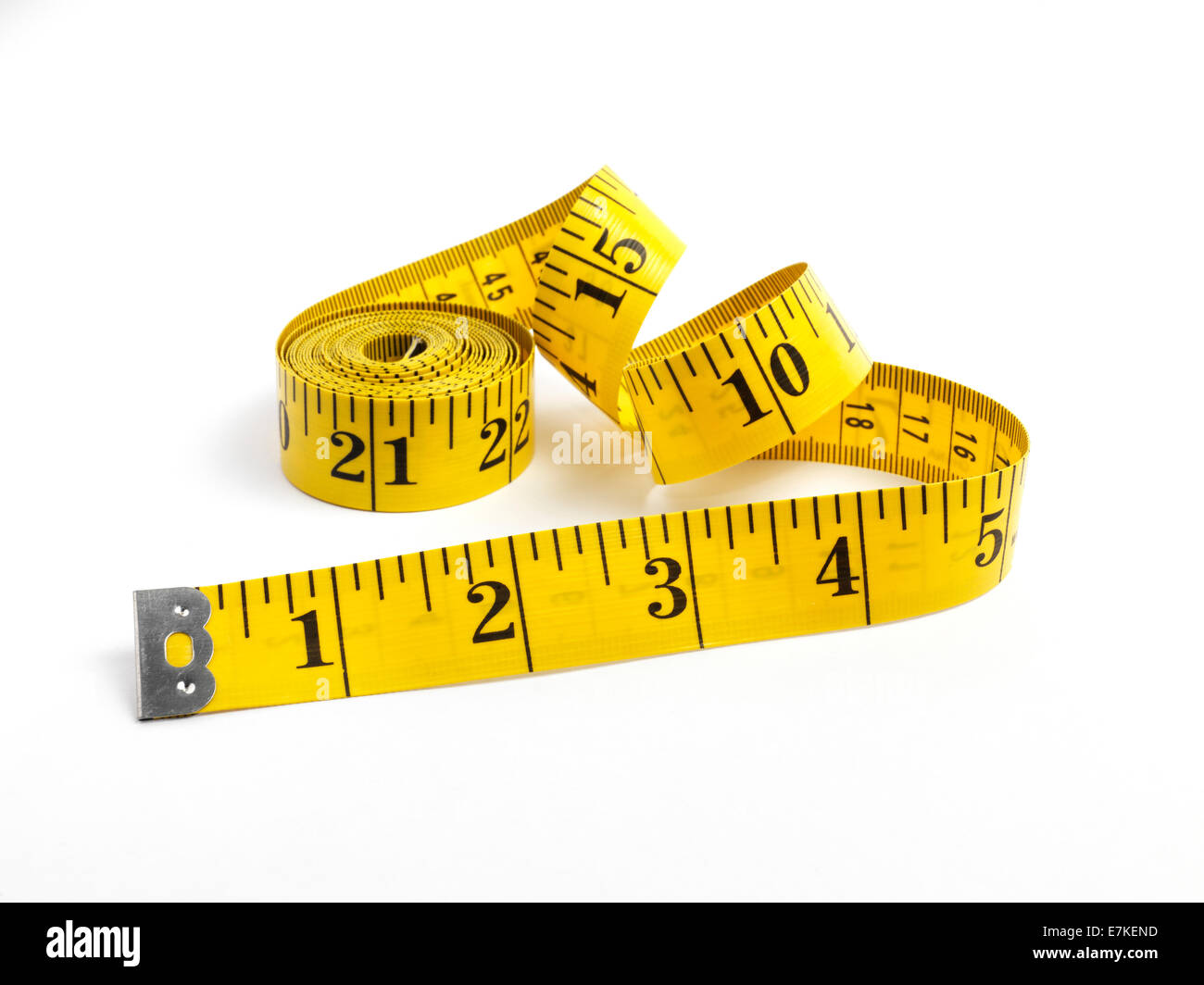 Isolated yellow tape measure on white Stock Photo