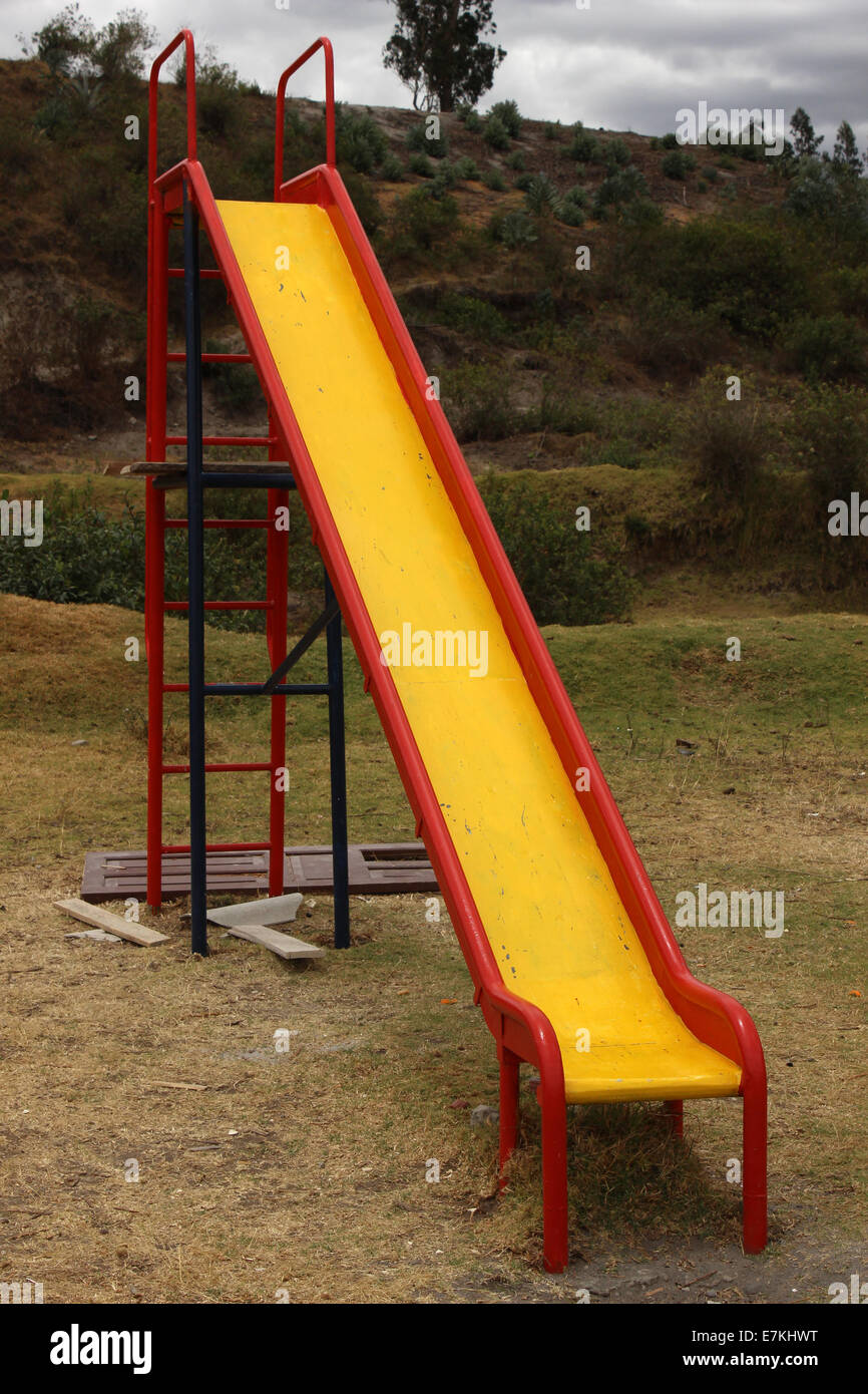 A painted steel slide on  a playground in a park in Cotacachi, Ecuador Stock Photo