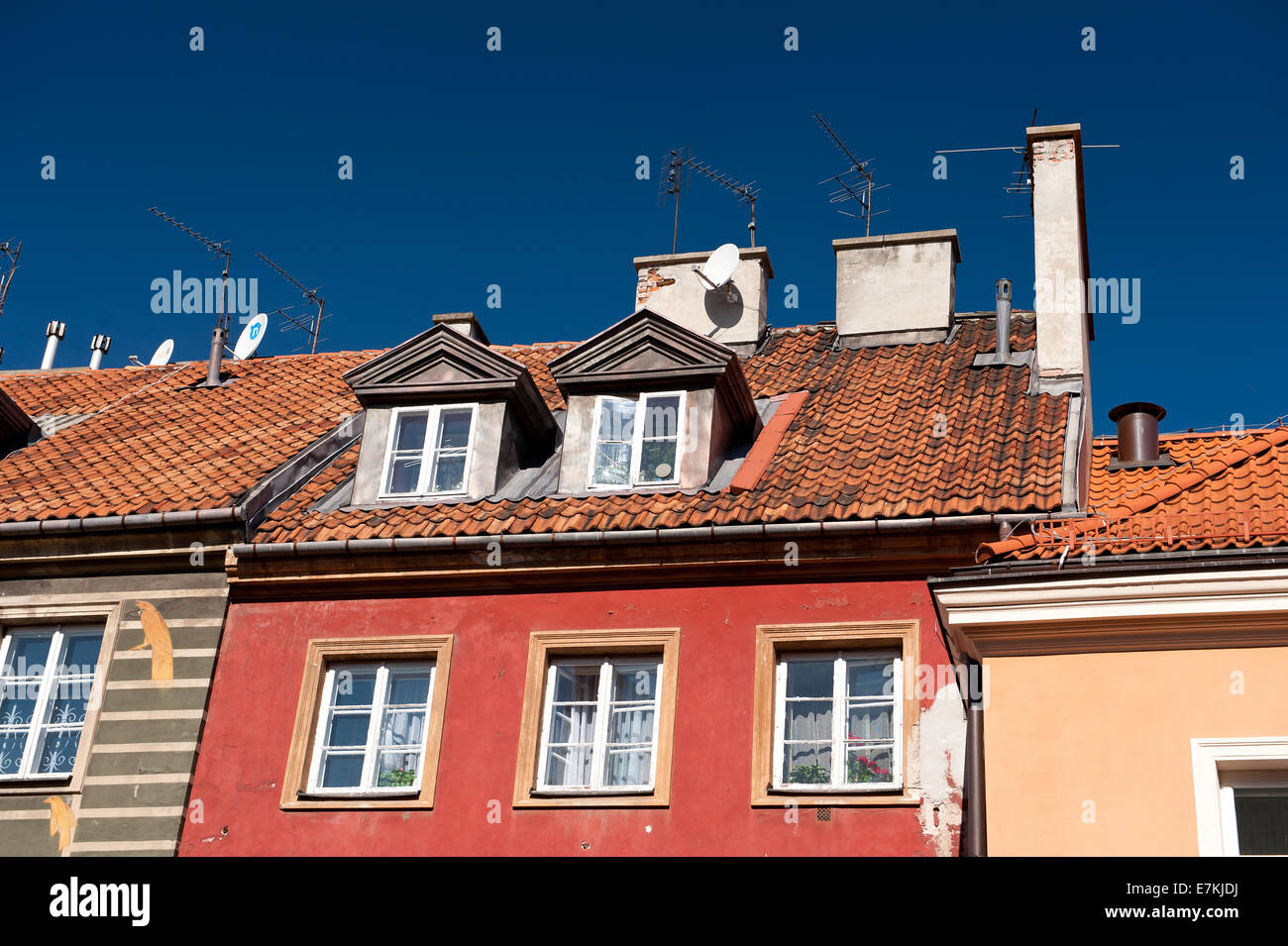 Red pitched roof old building with attic Stock Photo