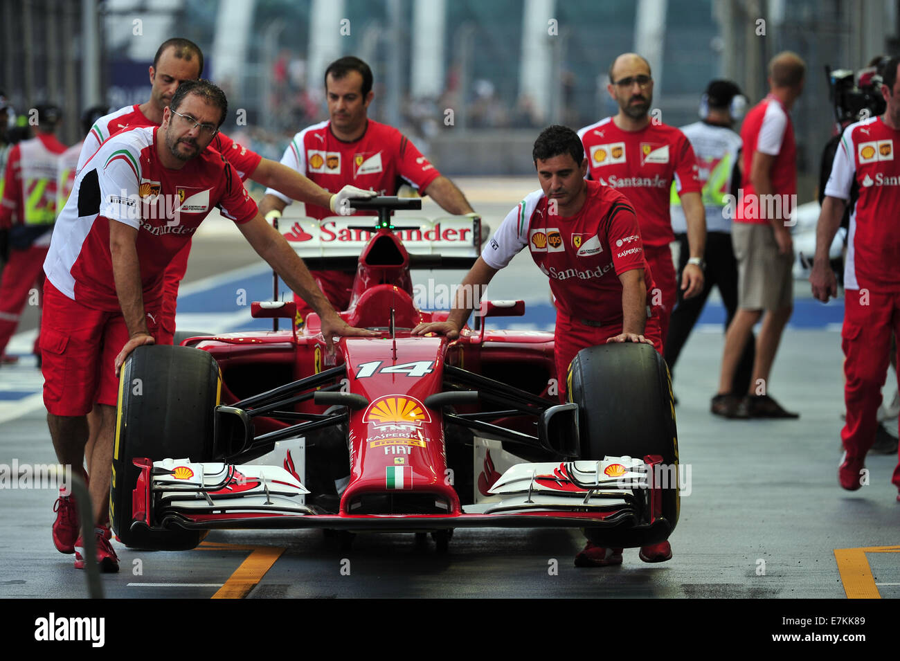 Singapore. 20th Sep, 2014. Team Ferrari pit crew push the car to the team garage before the third practice session at the Singapore F1 Night Race in Singapore, on Sept. 20, 2014. Credit:  Then Chih Wey/Xinhua/Alamy Live News Stock Photo