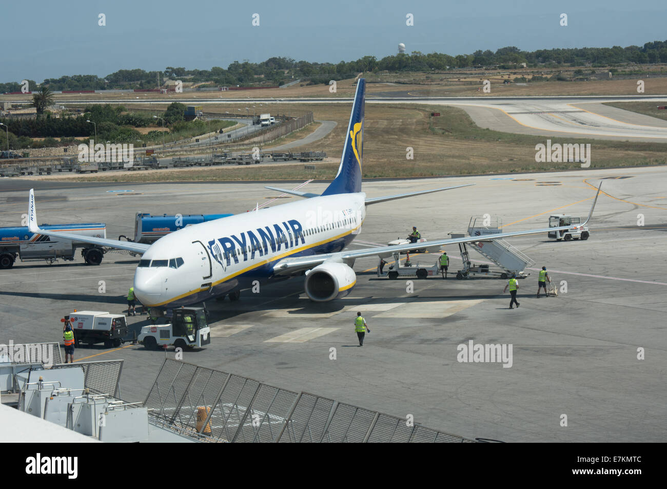 Airport workers prepare to unload a recently arrived Ryanair flight. at Malta International Airport Stock Photo
