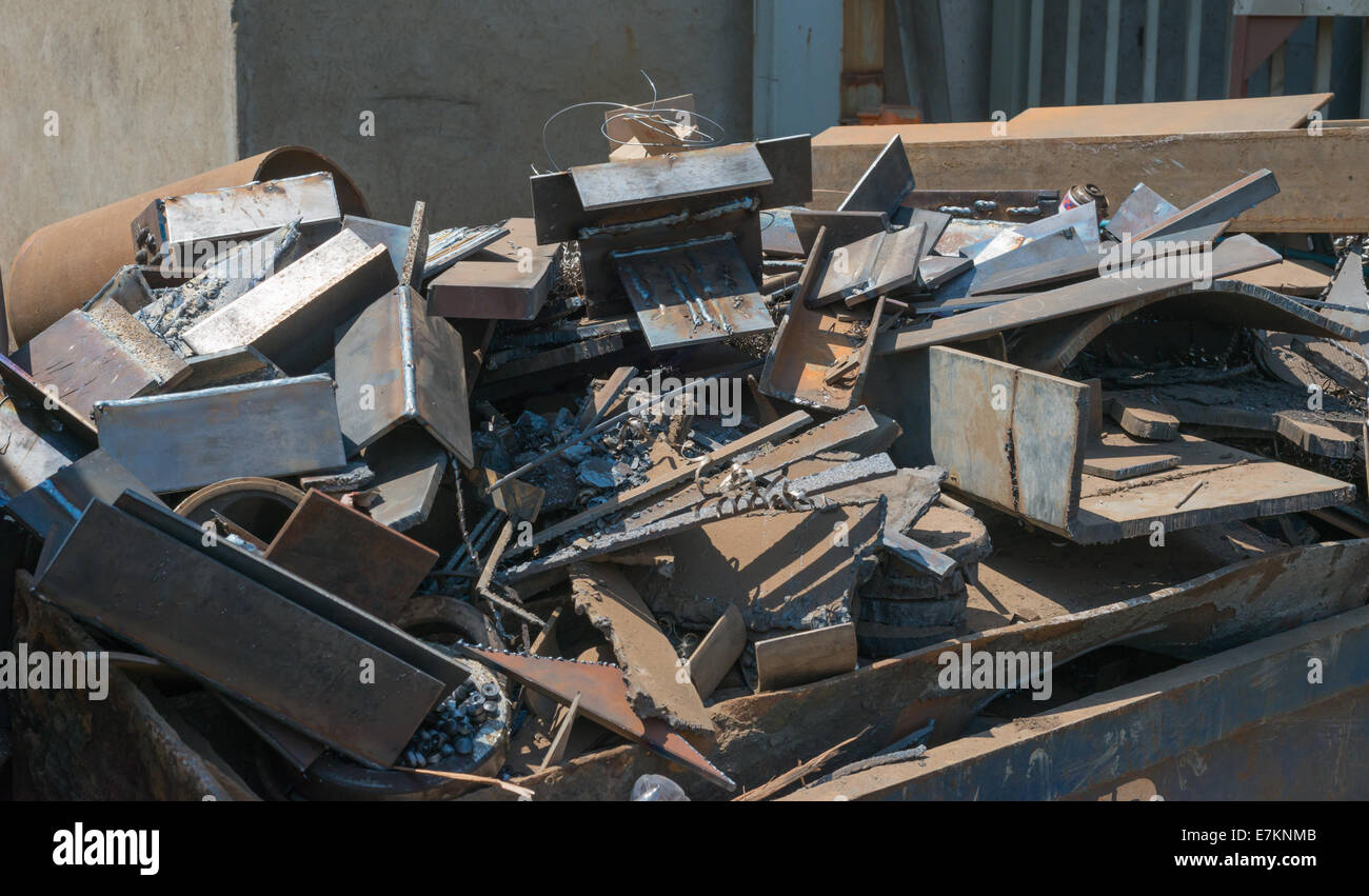A skip full of rusting scrap steel and other metal sits waiting for collection and recycling. Stock Photo