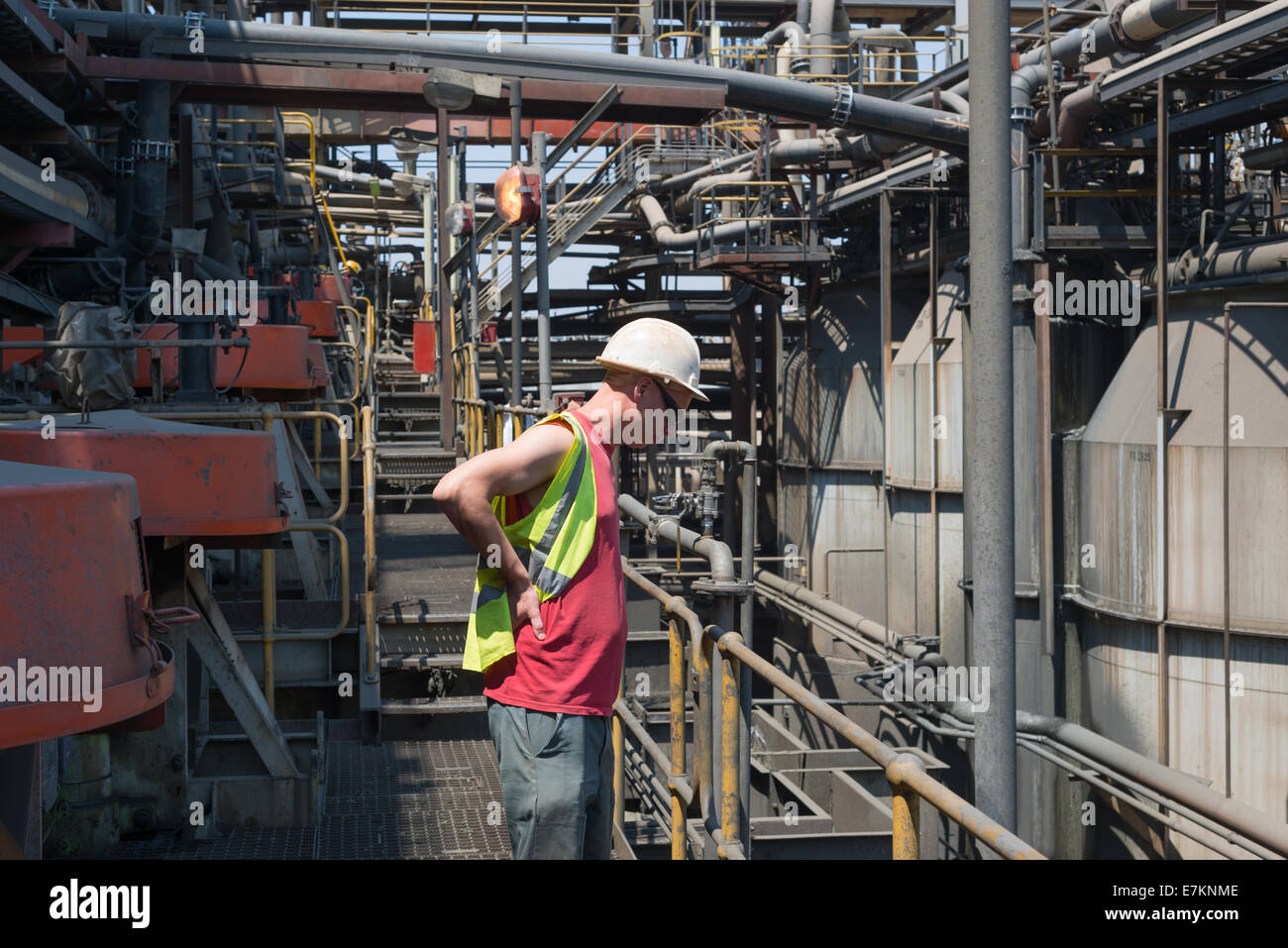 A white mine worker inspects the froth floatation product in an African copper beneficiation plant. Stock Photo