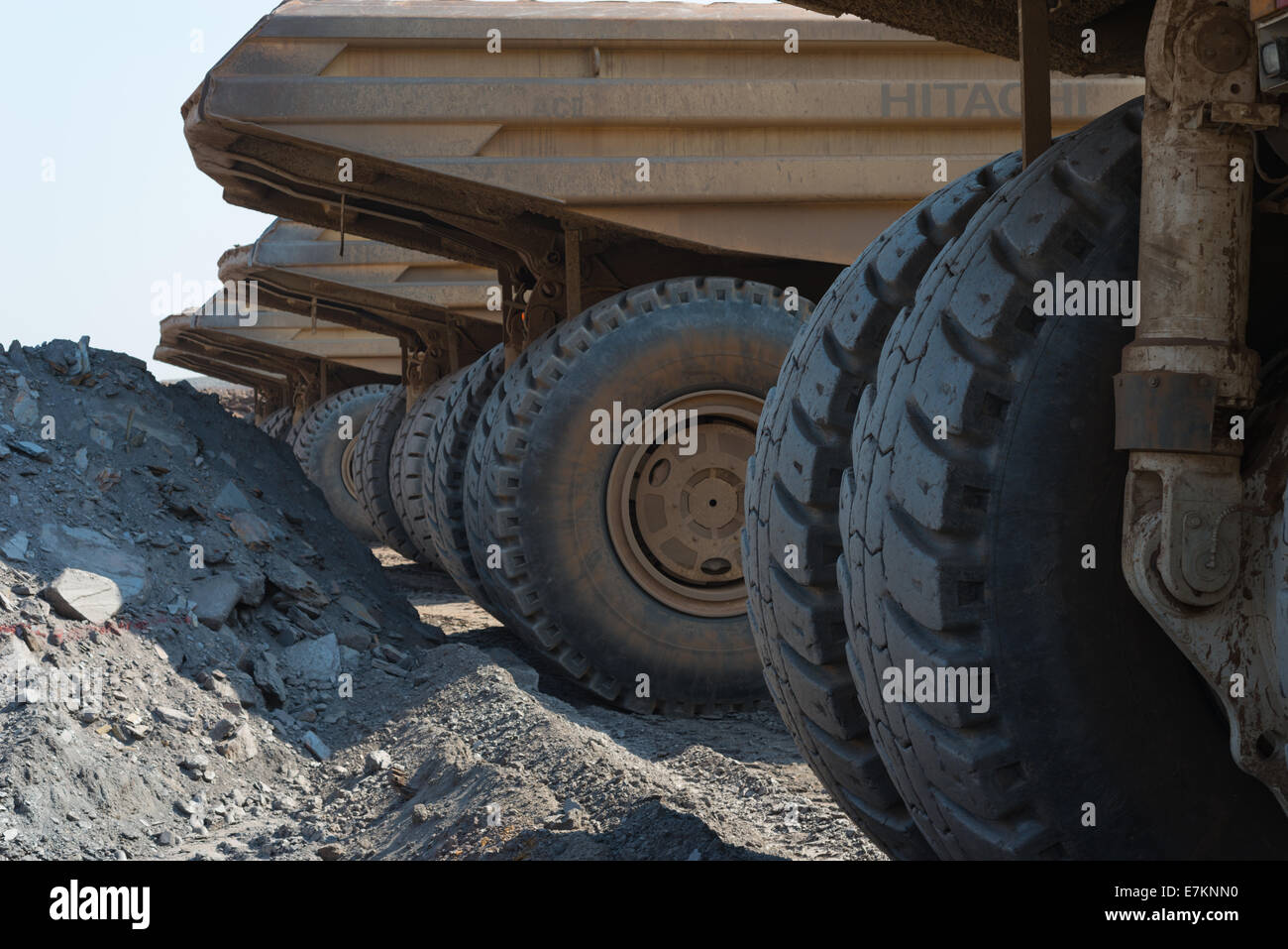 A mine employee climbs up the front of his Hitatchi dump truck during shift change. Stock Photo