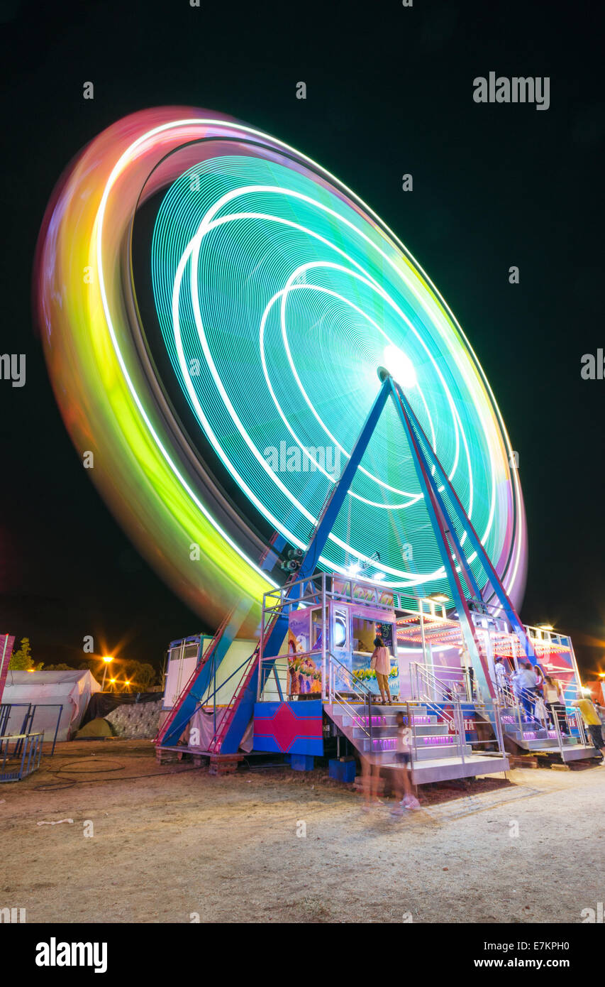 COLLADO VILLALBA, SPAIN - JULY 28: Long exposure picture of a Ferrys wheel rotating in a small local amusement park Stock Photo