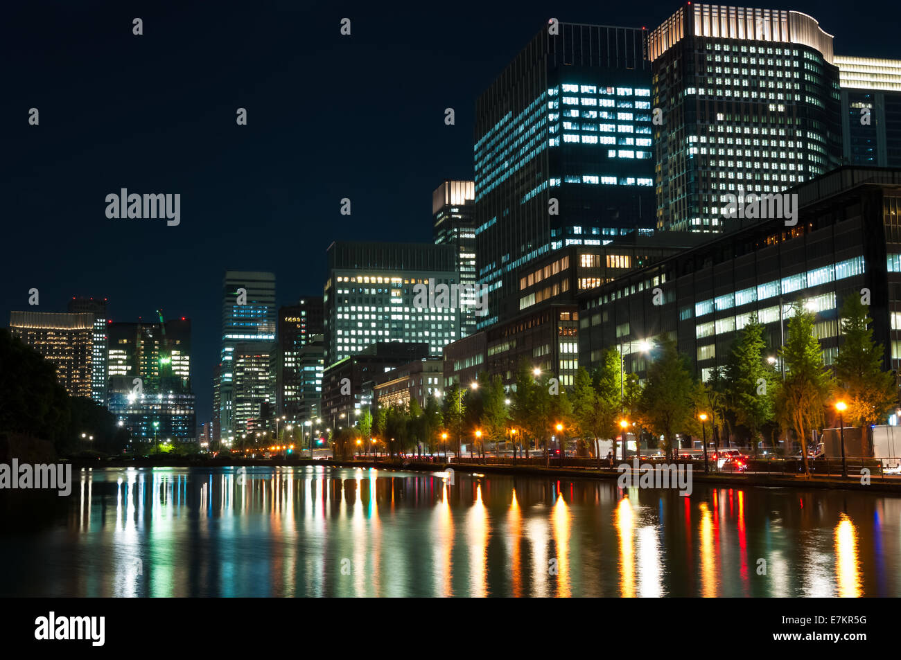 The city lights of Tokyo reflect off of the water. Stock Photo