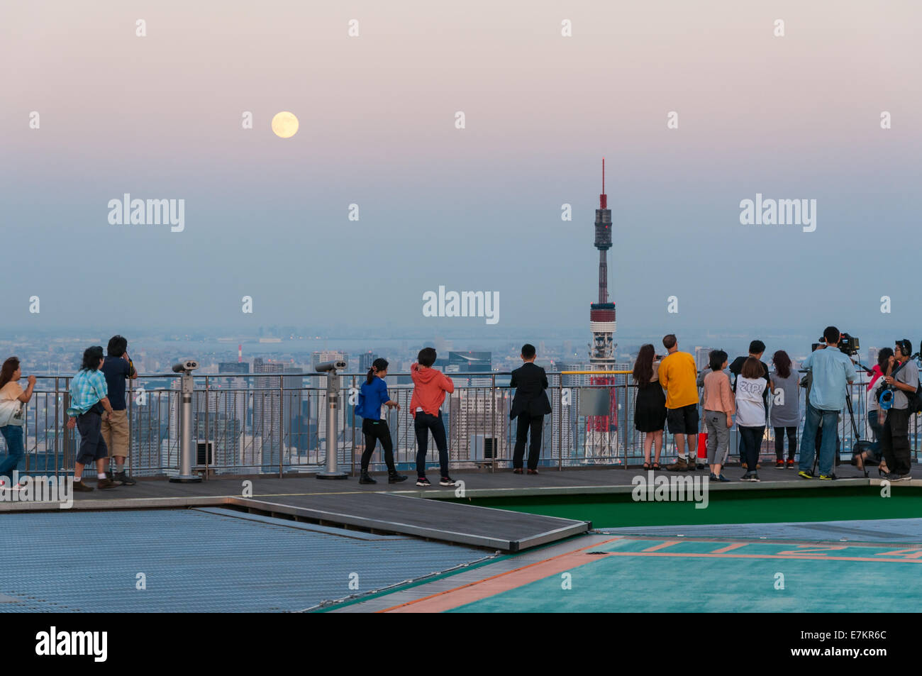 Photographers and tourists look out over the Tokyo cityscape from atop Mori Tower in Tokyo, Japan. Stock Photo