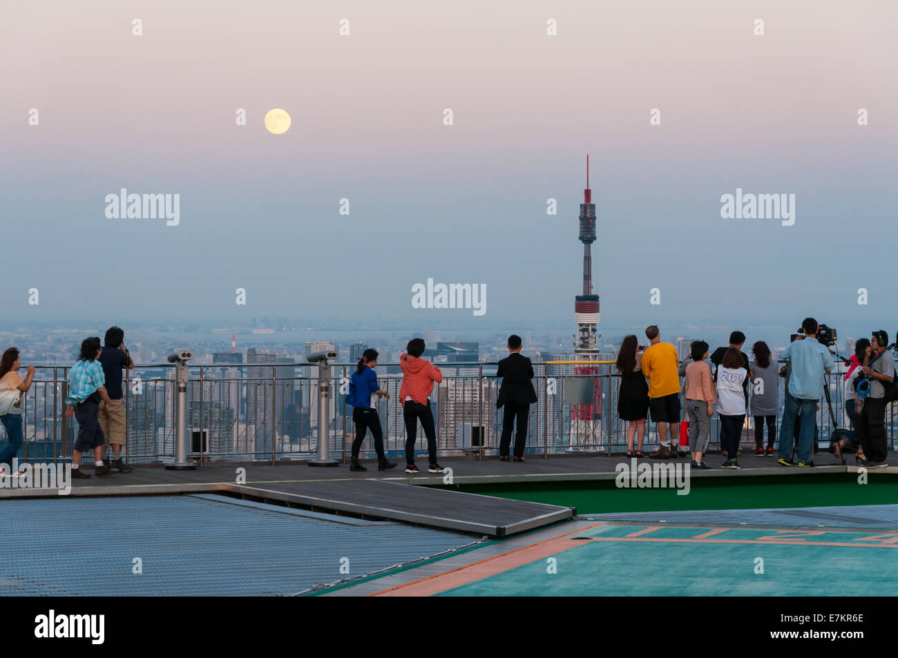 Photographers and tourists look out over the Tokyo cityscape from atop Mori Tower in Tokyo, Japan. Stock Photo