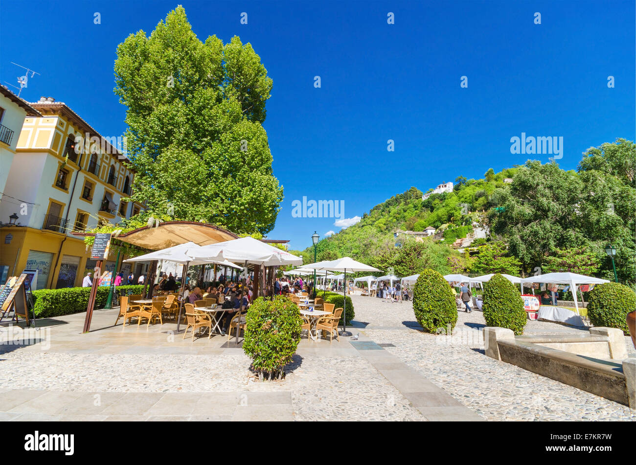 GRANADA, SPAIN - APRIL 26: Los tristes Boulevard on April 26, 2014 in Granada, Spain. Some tourist relaxing in a terrace, in the Stock Photo