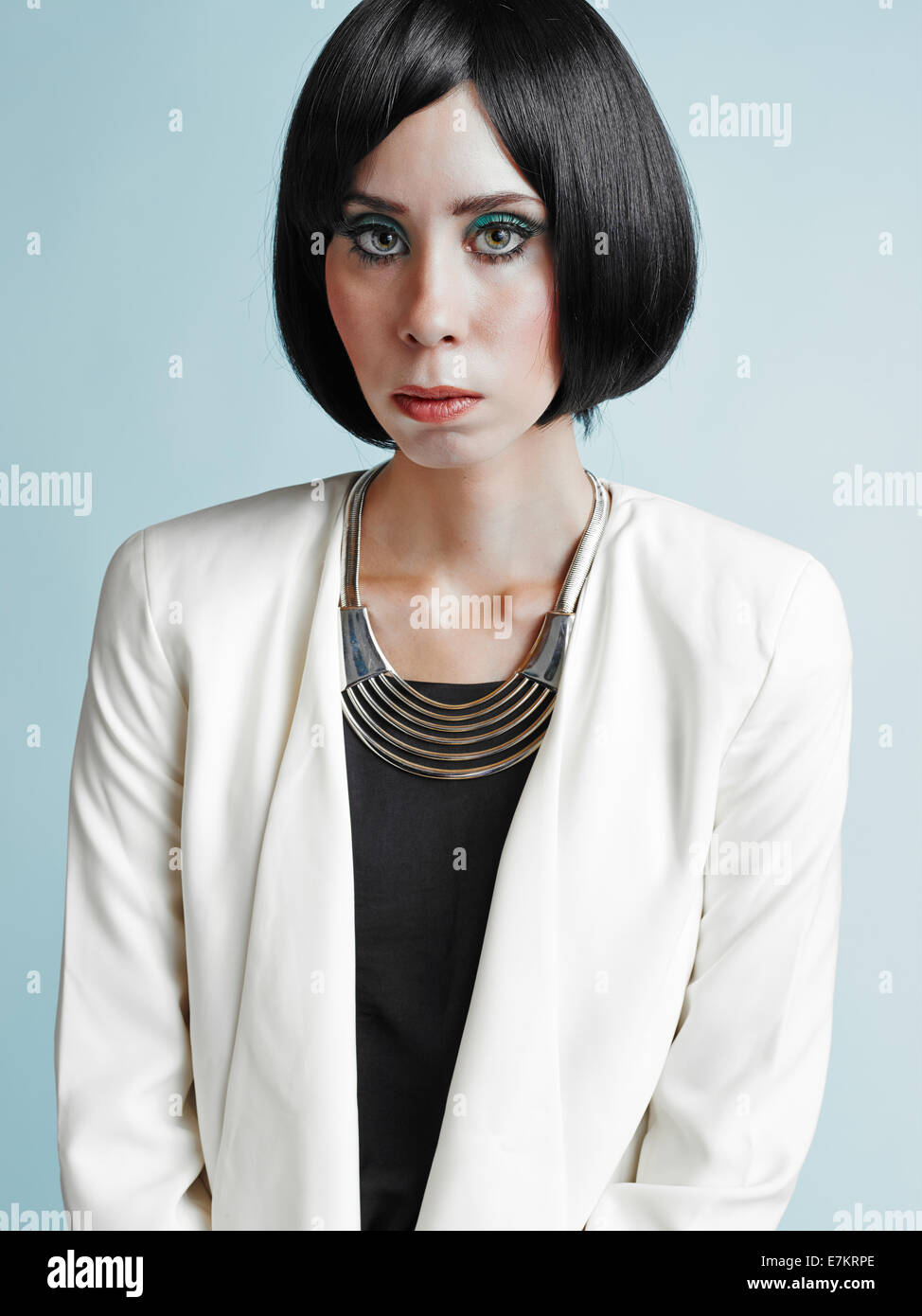 Close up portrait of beautiful young woman wearing white jacket - studio shot Stock Photo