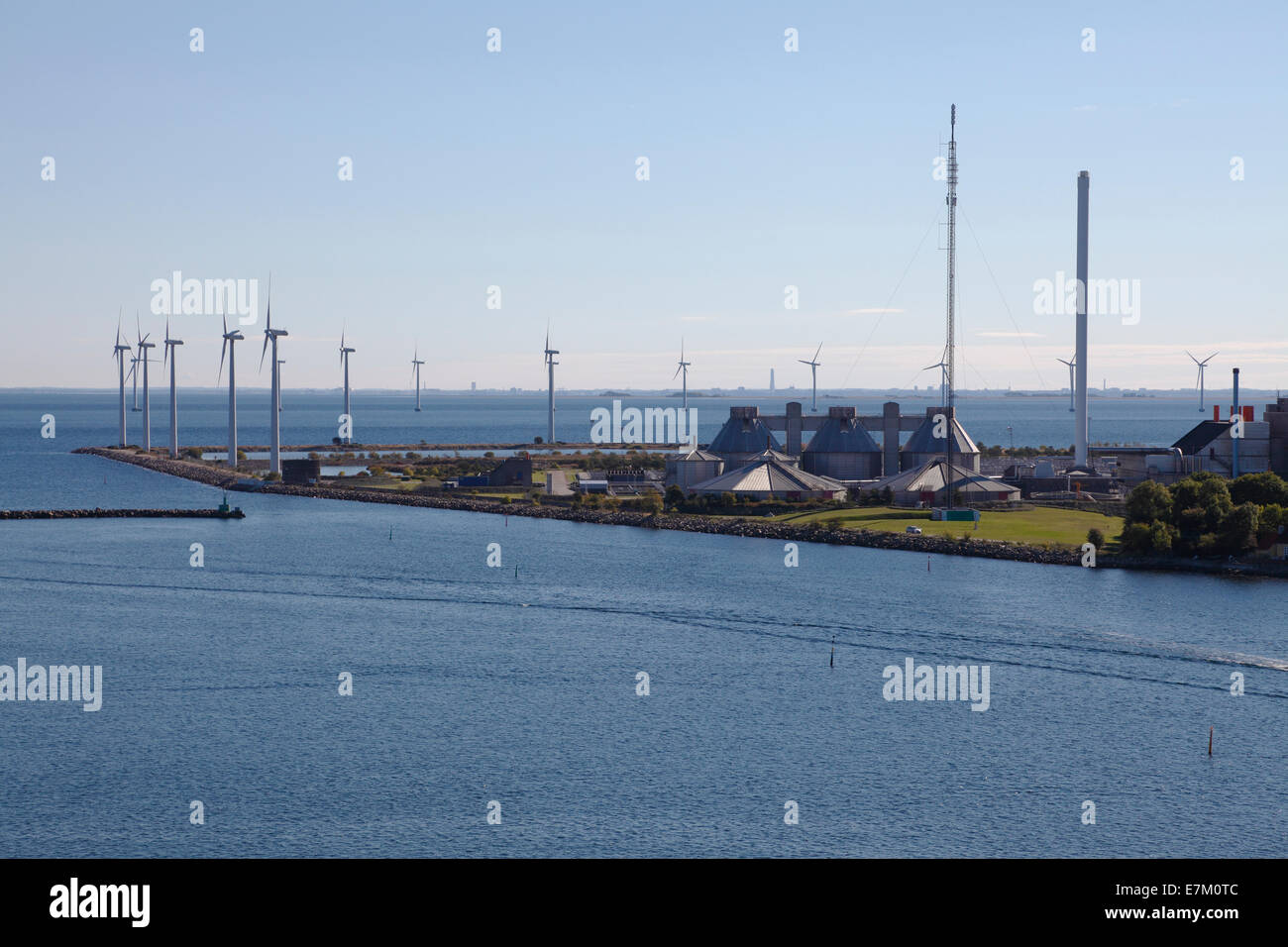 Lynetten wastewater treatment plant and wind turbines along the yacht entrance, to the port of Copenhagen. Offshore wind park Middelgrund in distance. Stock Photo