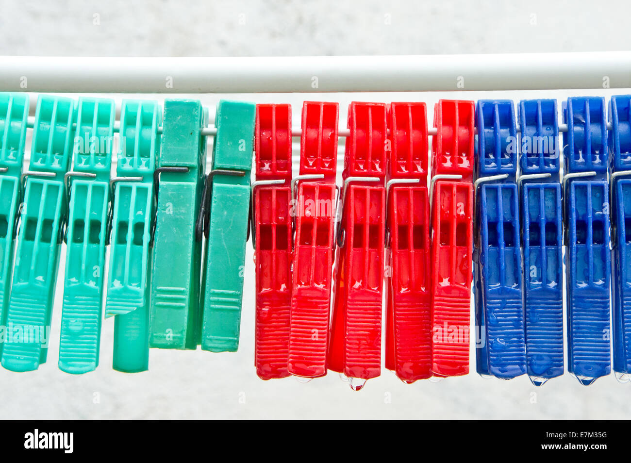 Colorful clothes pegs on a line with water drops Stock Photo Alamy