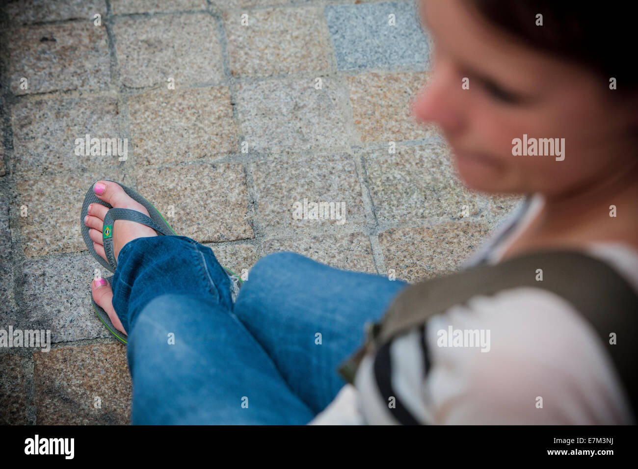 Girl with nail polish and flip flop sandals blue jeans relaxing on holiday  free spirit Stock Photo - Alamy
