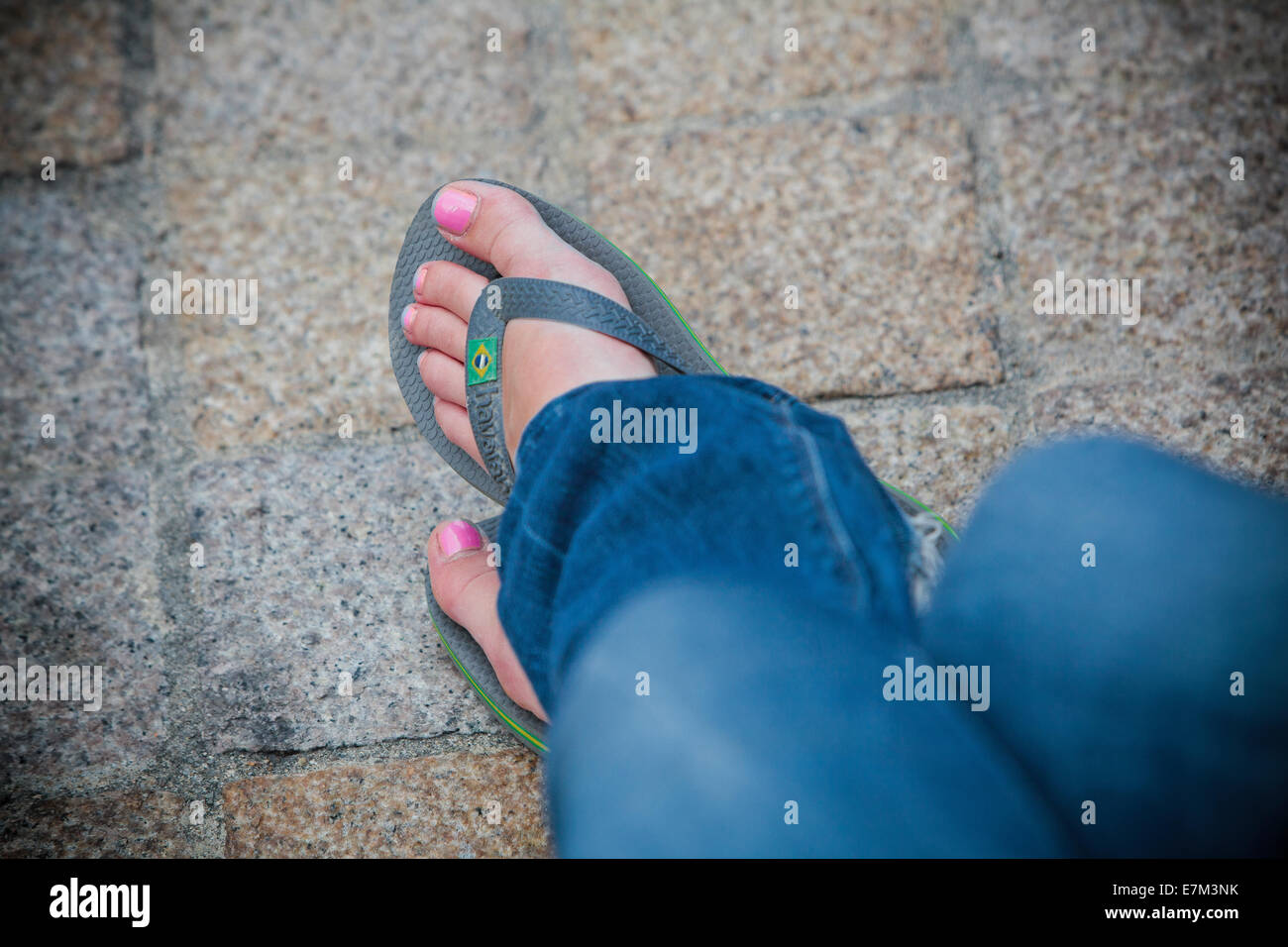 Girl with nail polish and flip flop sandals blue jeans relaxing on holiday  free spirit Stock Photo - Alamy