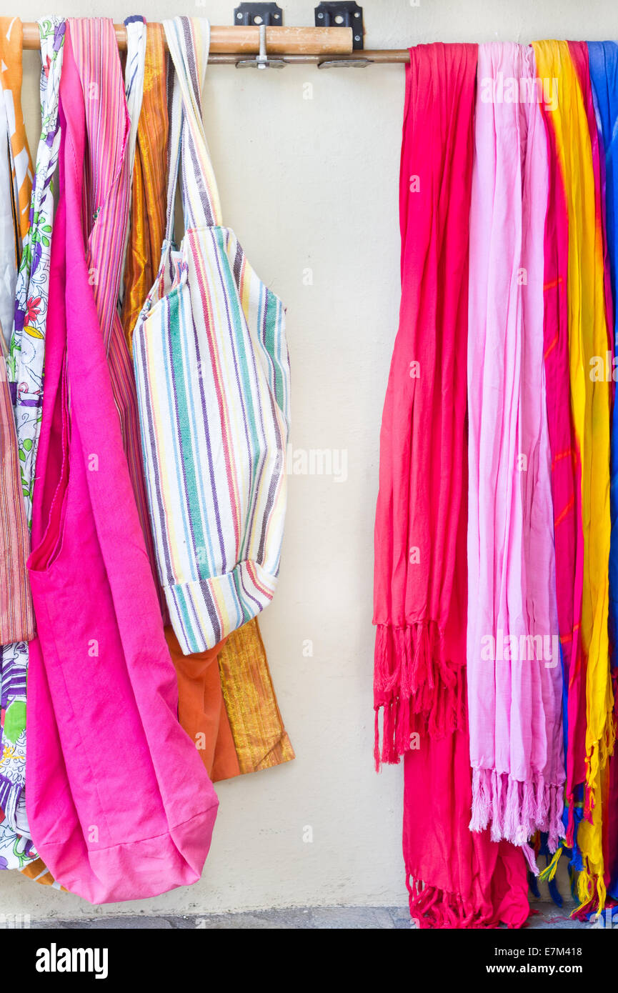 Vibrant scarves and bags on a rack at a store Stock Photo