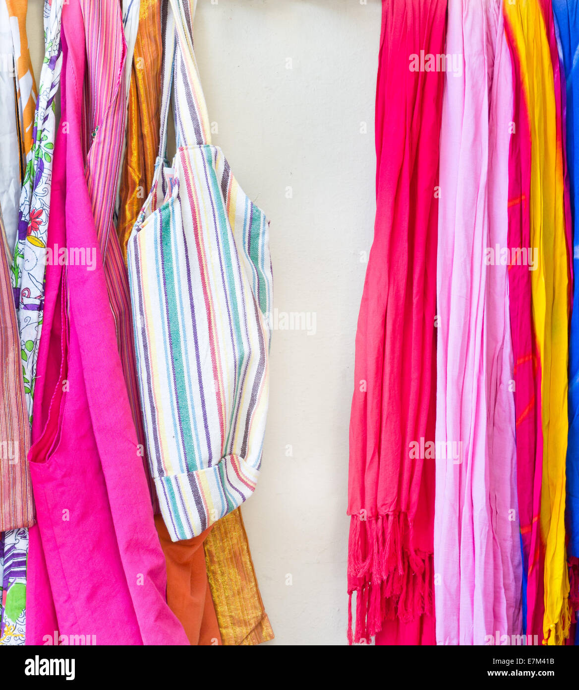 Vibrant scarves and bags on a rack at a store Stock Photo