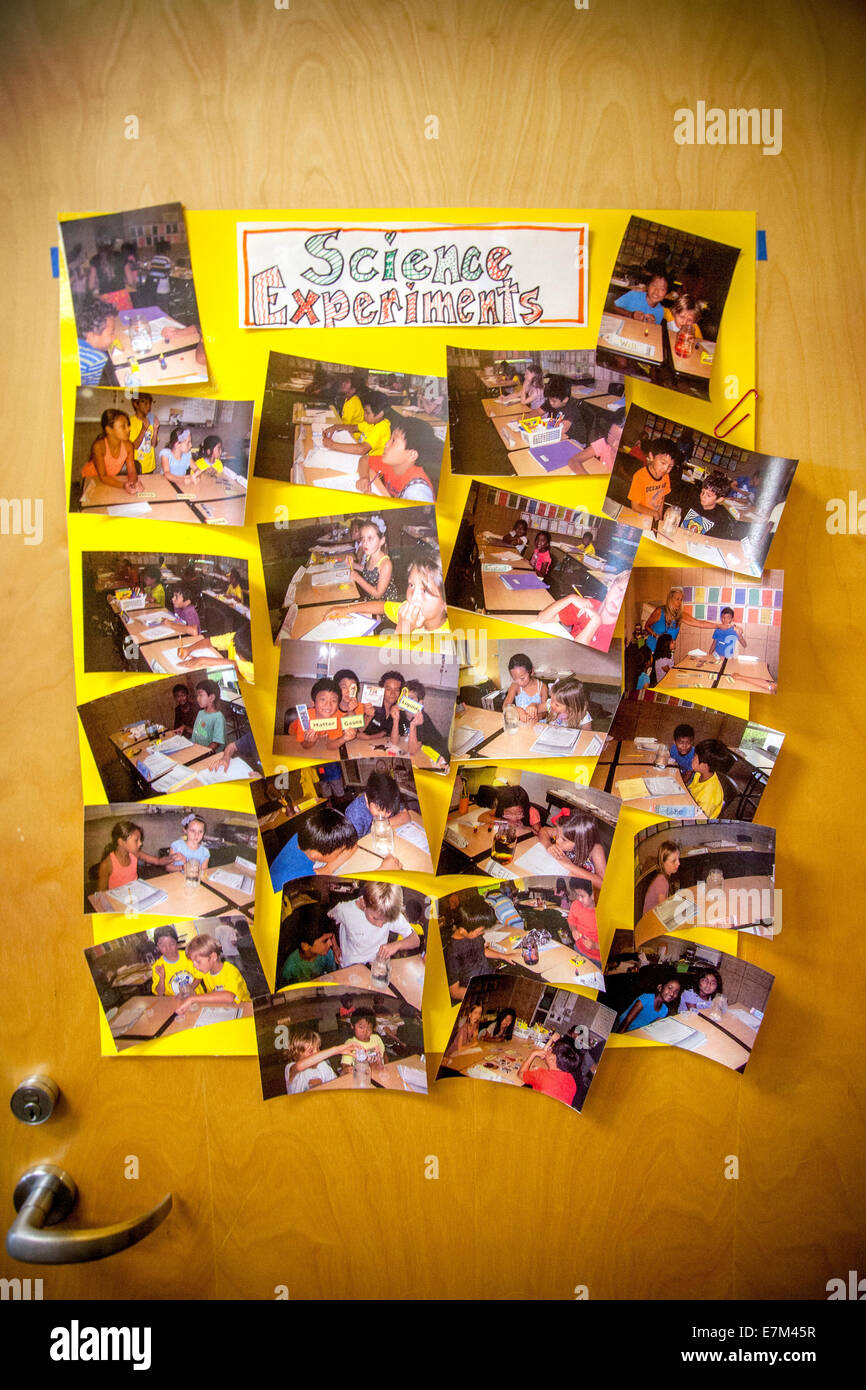 Snapshot photos of Irvine, CA, elementary school students' science experiments are displayed on the door of their classroom. Stock Photo