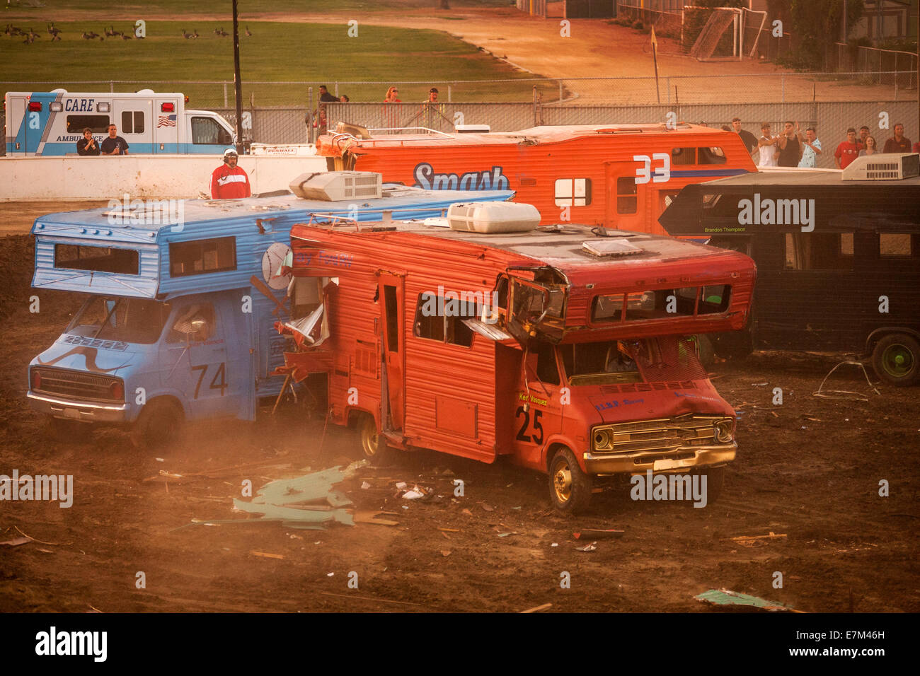 Brightly painted motor homes crash together in a demolition derby at
