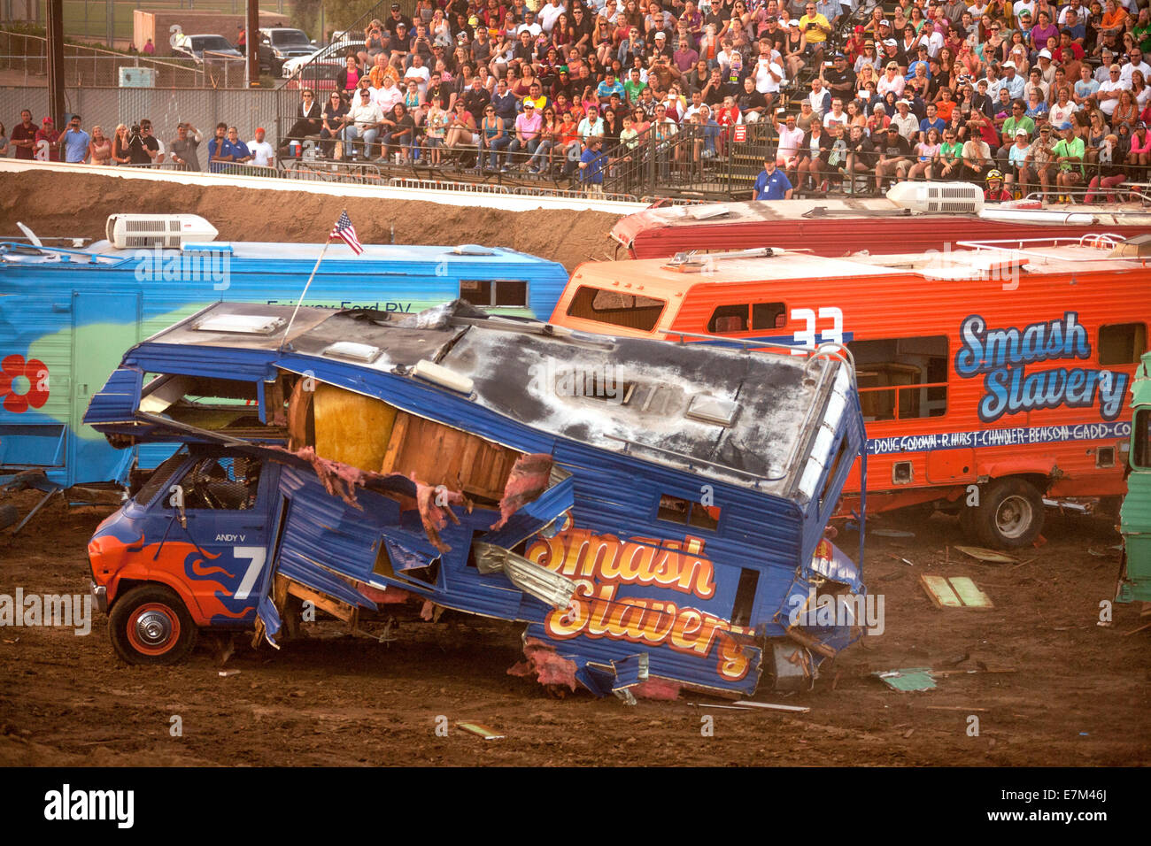 Brightly painted motor homes crash together in a demolition derby at