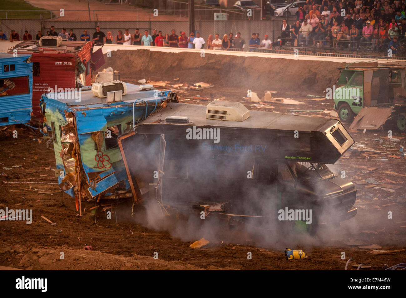 Brightly painted motor homes crash together in a demolition derby at