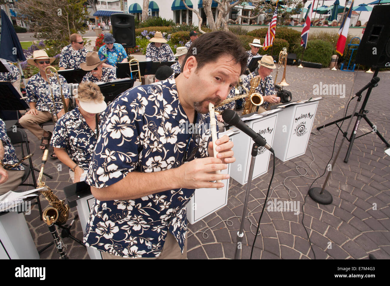 The leader of an outdoor band plays a penny whistle during a music festival in Laguna Beach, CA. Stock Photo