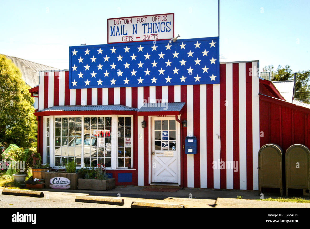 A post office in rural Drytown, CA, is decked out patriotically in the stars and stripes of the U.S. flag. Stock Photo