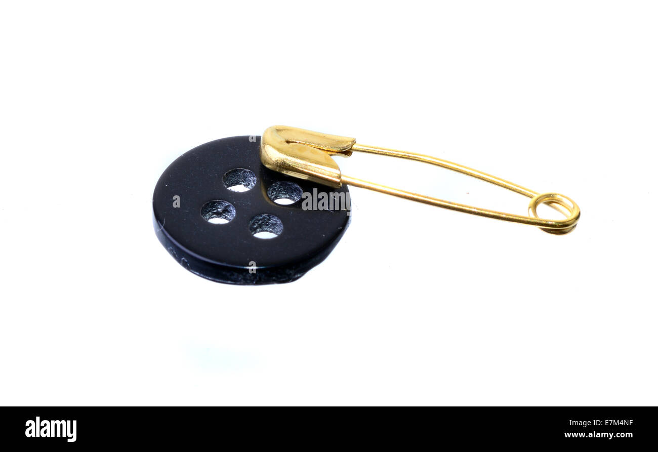 Black button and safety pin isolated on white Stock Photo