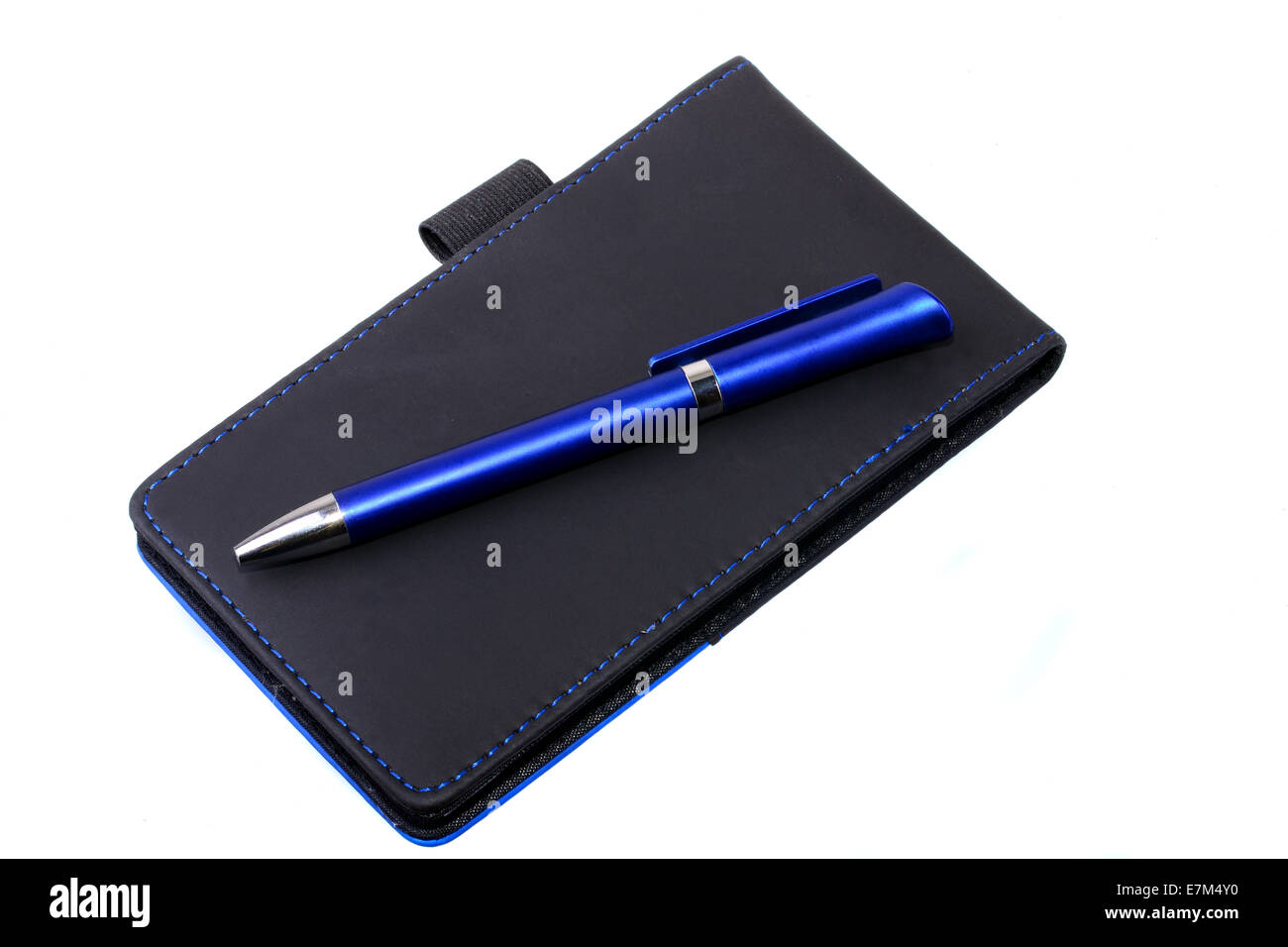 Blue pen over note pad isolated on a white background Stock Photo - Alamy