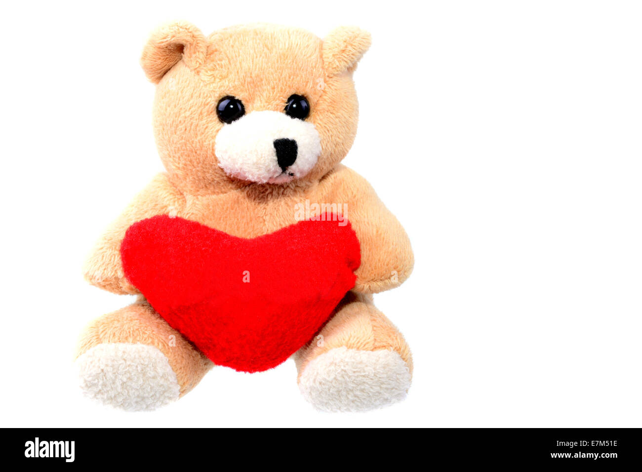 Small teddy bear holding a red heart isolated on white with copy space Stock Photo