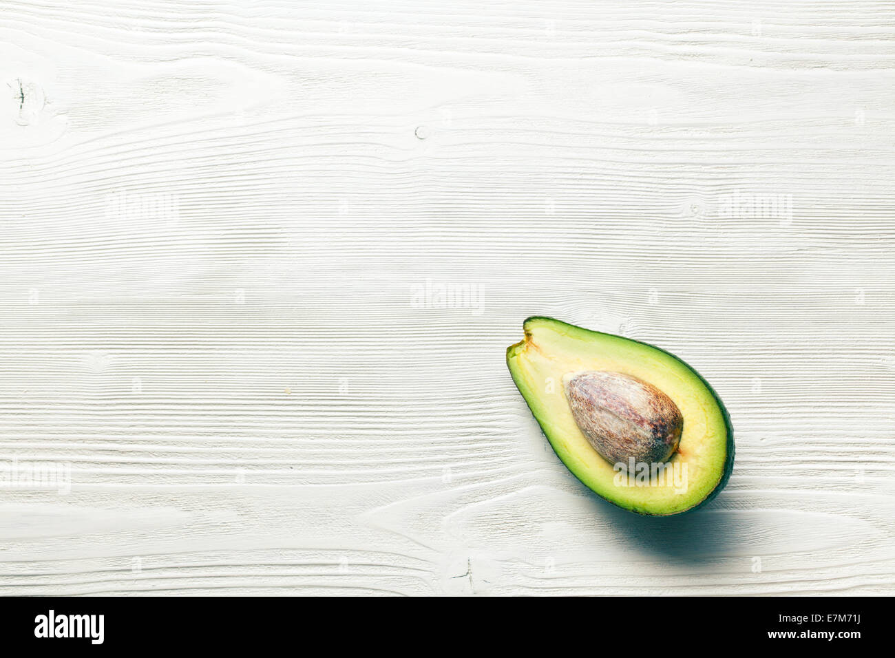 top view of halved avocados on wooden background Stock Photo - Alamy