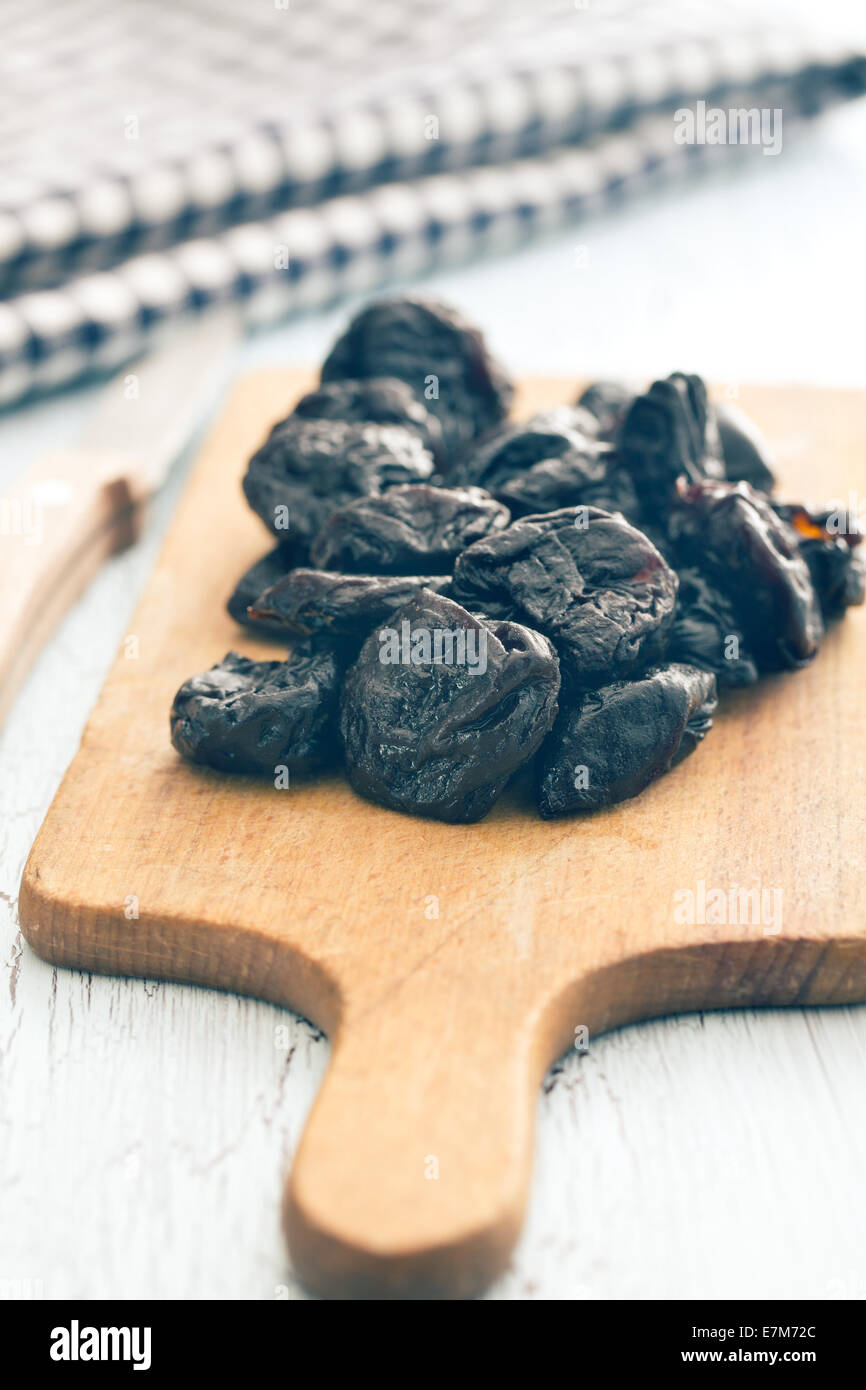 pitted prunes on old table Stock Photo