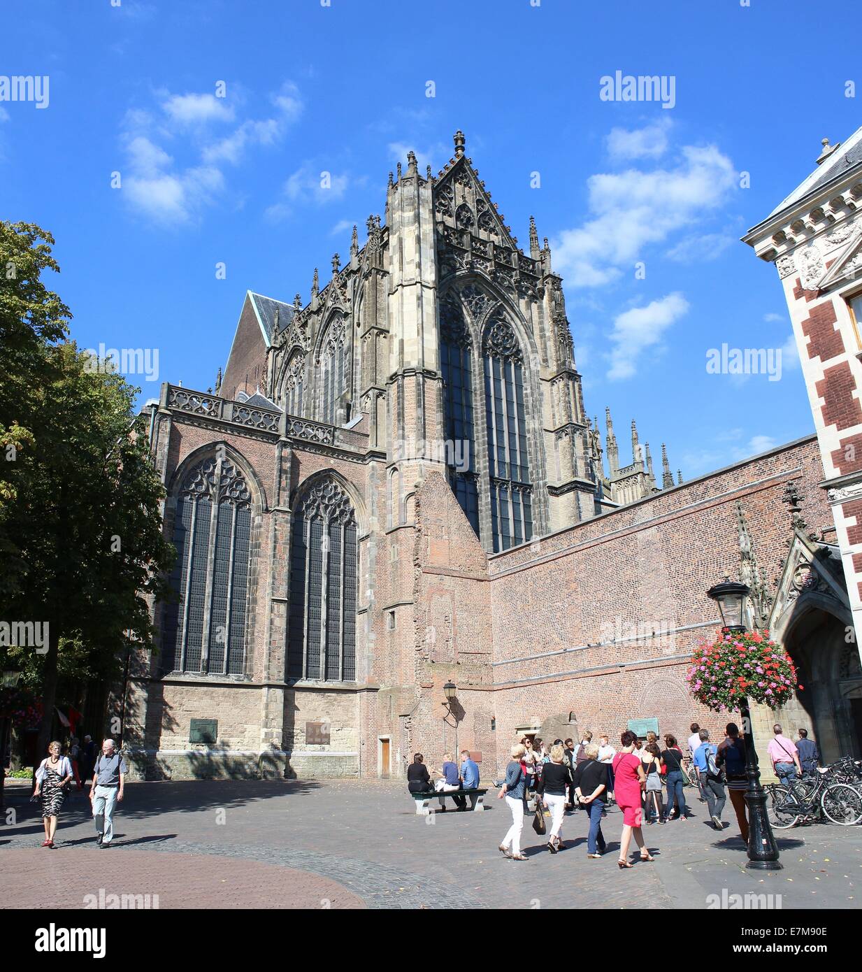 Exterior of the gothic Dom church or St. Martin's Cathedral in Utrecht, The Netherlands. Group of tourists visiting Dom Square Stock Photo
